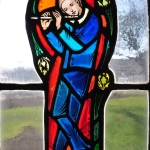 Stained Glass portait of Stephen Foster, playing a flute