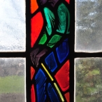 Stained glass depicting a presumably African-American character from Stephen Foster's songs, full character standing