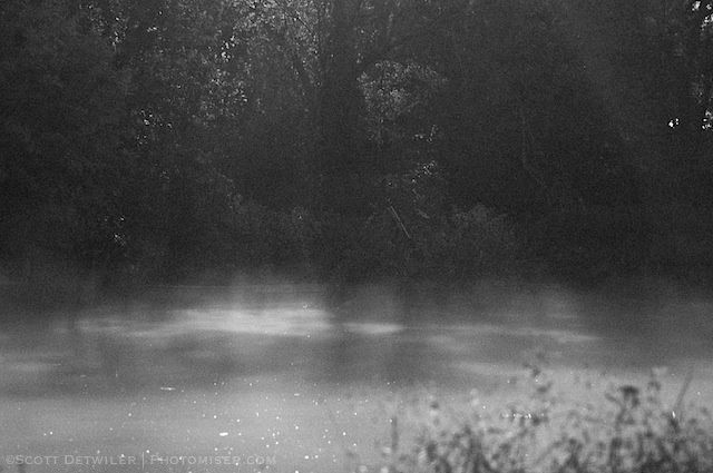 Misty pond illuminated by moonlight